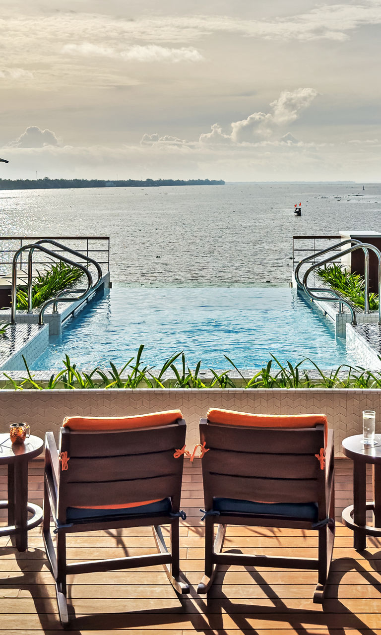 Luxury waterfront pool with lounge seating