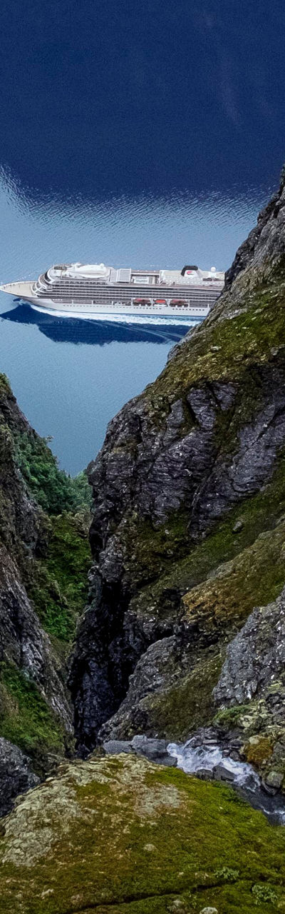 Cruise ship in scenic mountain fjord