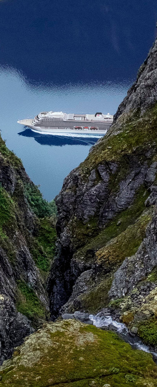 Cruise ship in scenic mountain fjord