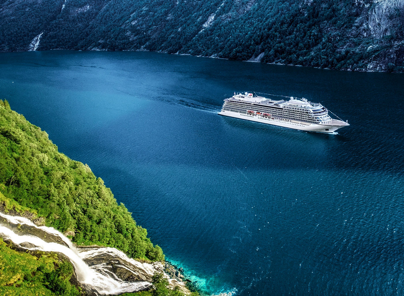 Cruise ship sailing through scenic fjord