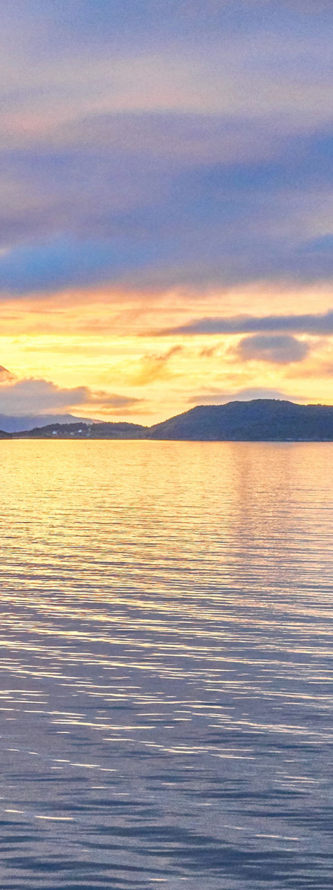 Luxury cruise ship at sunset on calm waters