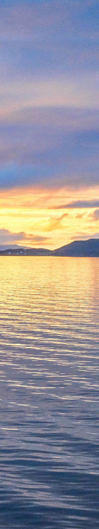 Luxury cruise ship at sunset on calm waters
