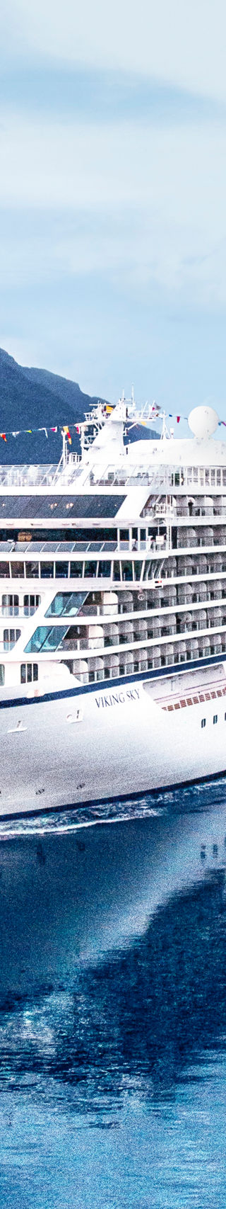 Luxury cruise ship in scenic fjord