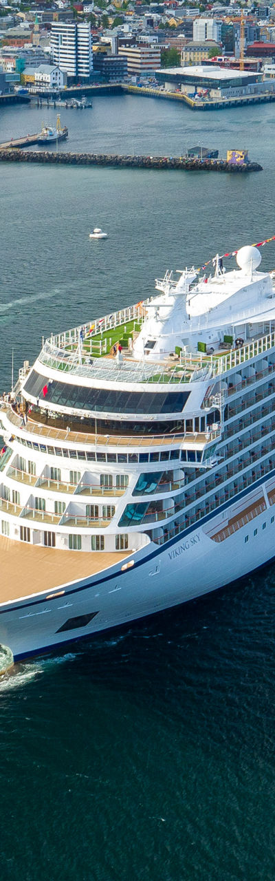 Luxury cruise ship in scenic harbor