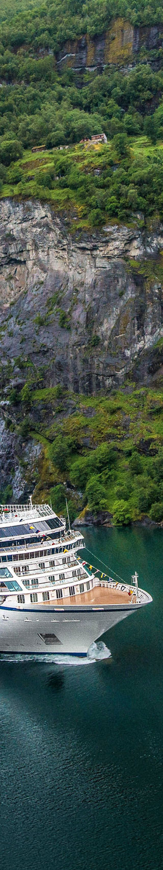 Cruise ship near scenic waterfall fjord