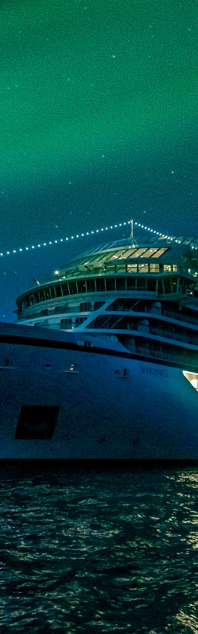 Luxury cruise ship under northern lights