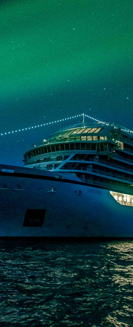 Luxury cruise ship under northern lights