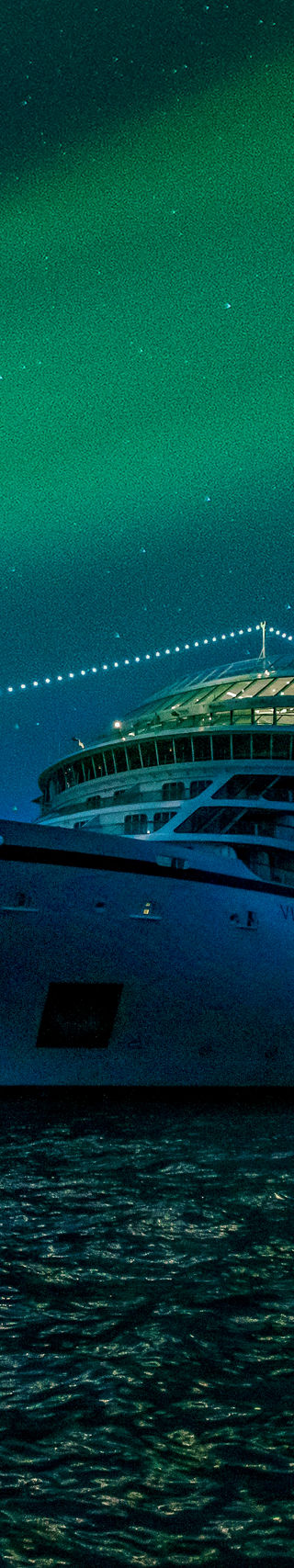 Luxury cruise ship under northern lights