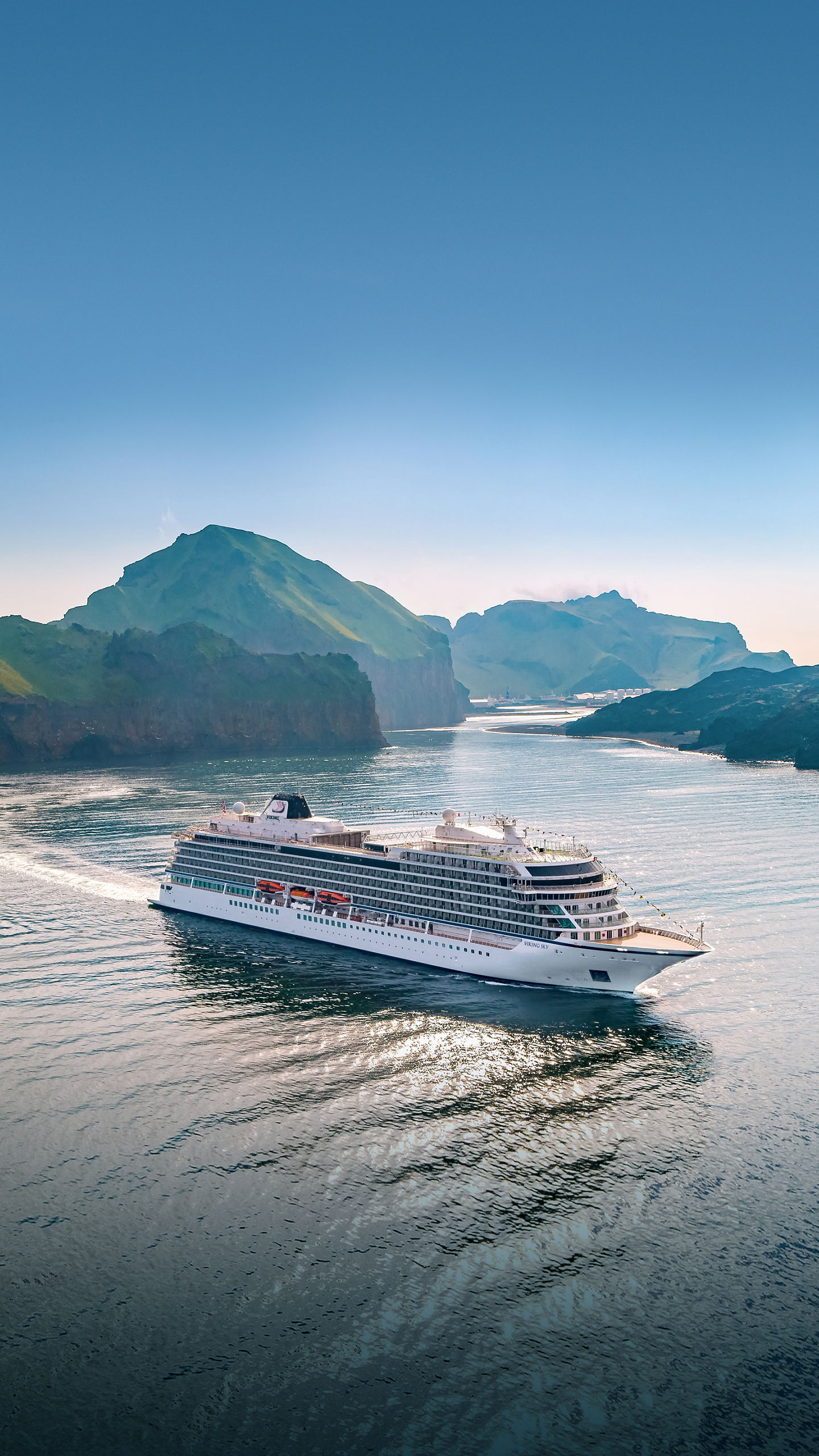 Luxury cruise ship sailing through scenic fjords