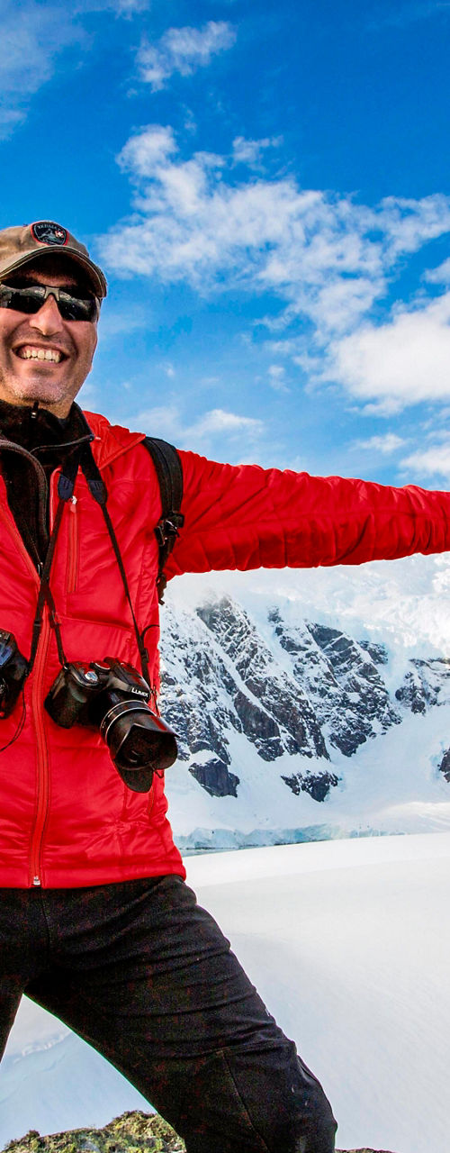 Explorer in snowy mountain landscape