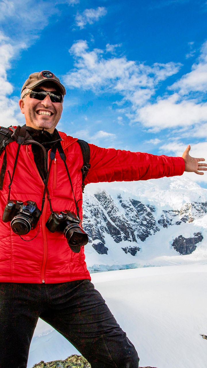 Explorer in snowy mountain landscape
