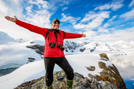 Explorer in snowy mountain landscape