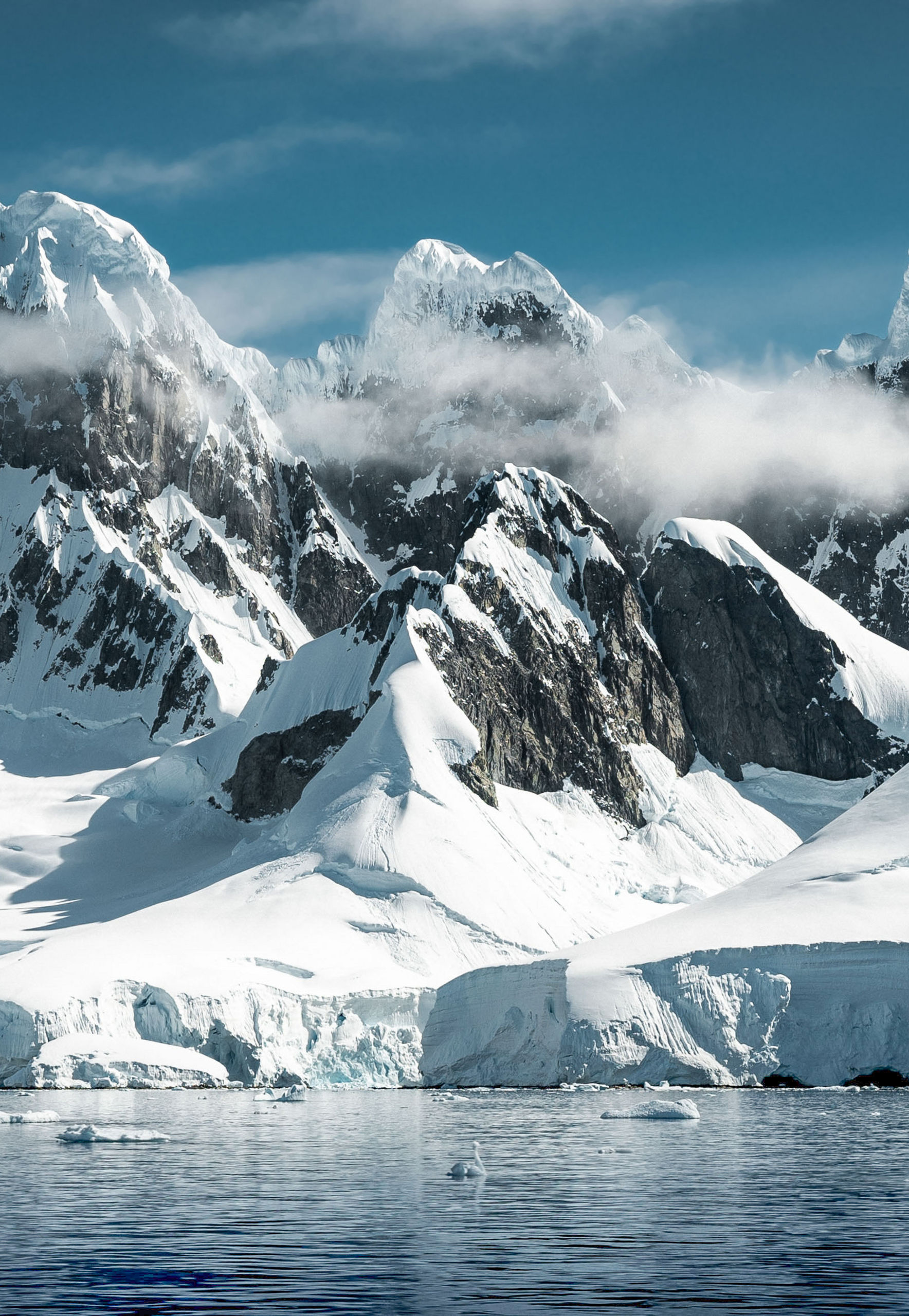 Snow-covered Antarctic mountains and icy waters