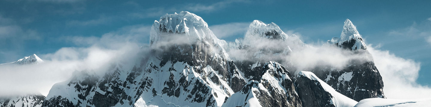 Snow-covered Antarctic mountains and icy waters