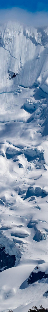 Majestic snow-covered mountain under blue sky