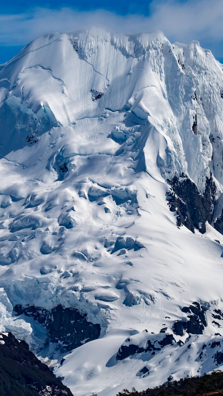 Majestic snow-covered mountain under blue sky