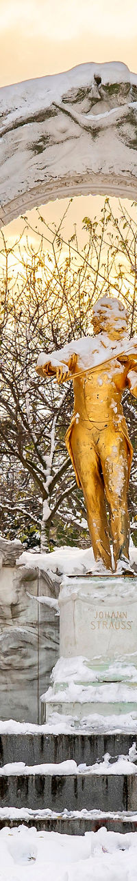 Golden statue in snowy park setting
