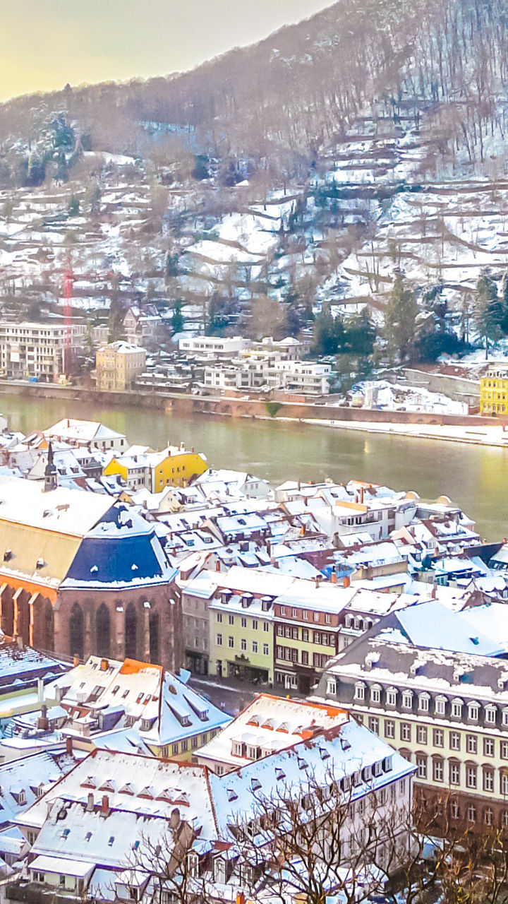 Snow-covered Heidelberg cityscape with river view