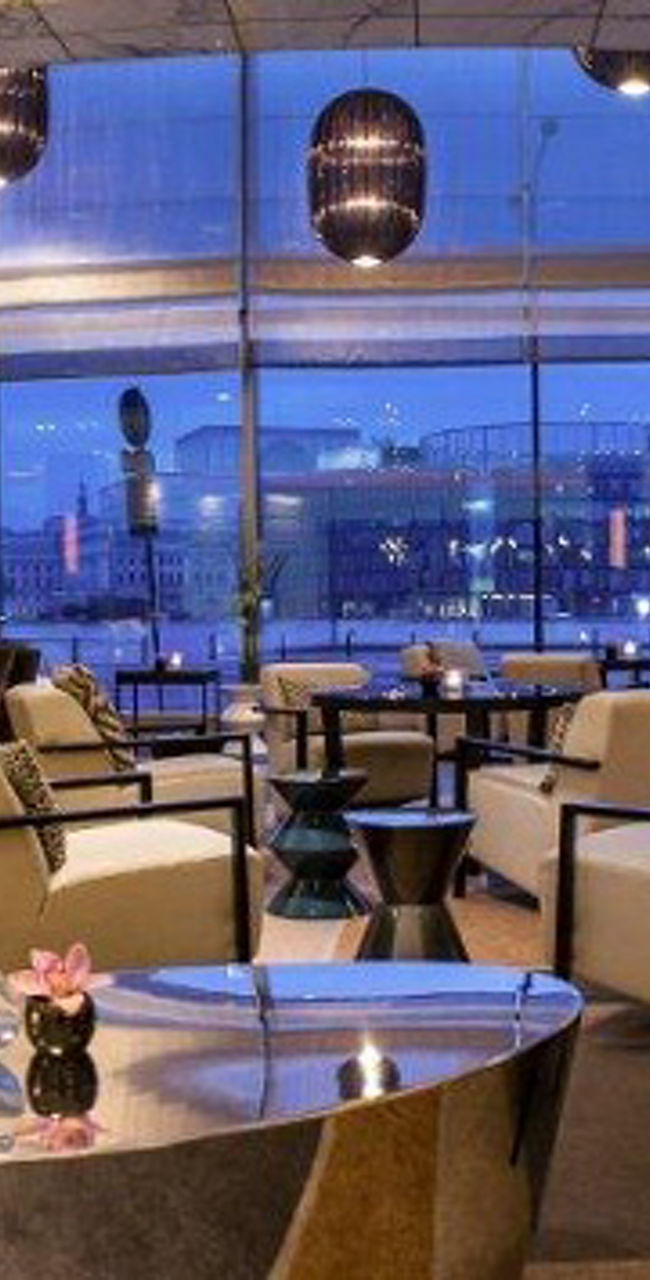 Modern lounge with city view at dusk