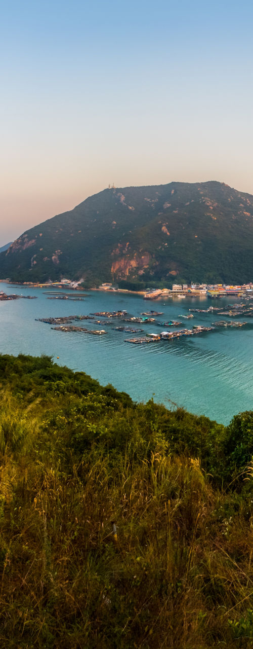 Scenic view of coastal town and mountains
