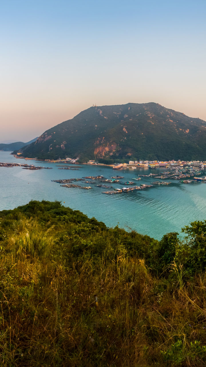 Scenic view of coastal town and mountains