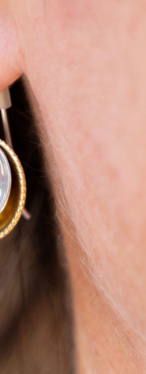 Close-up of metallic drop earrings