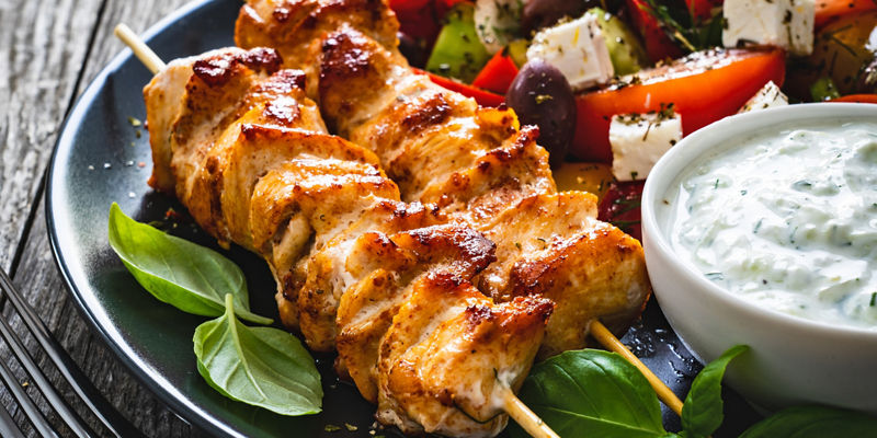 Grilled chicken skewers with Greek salad