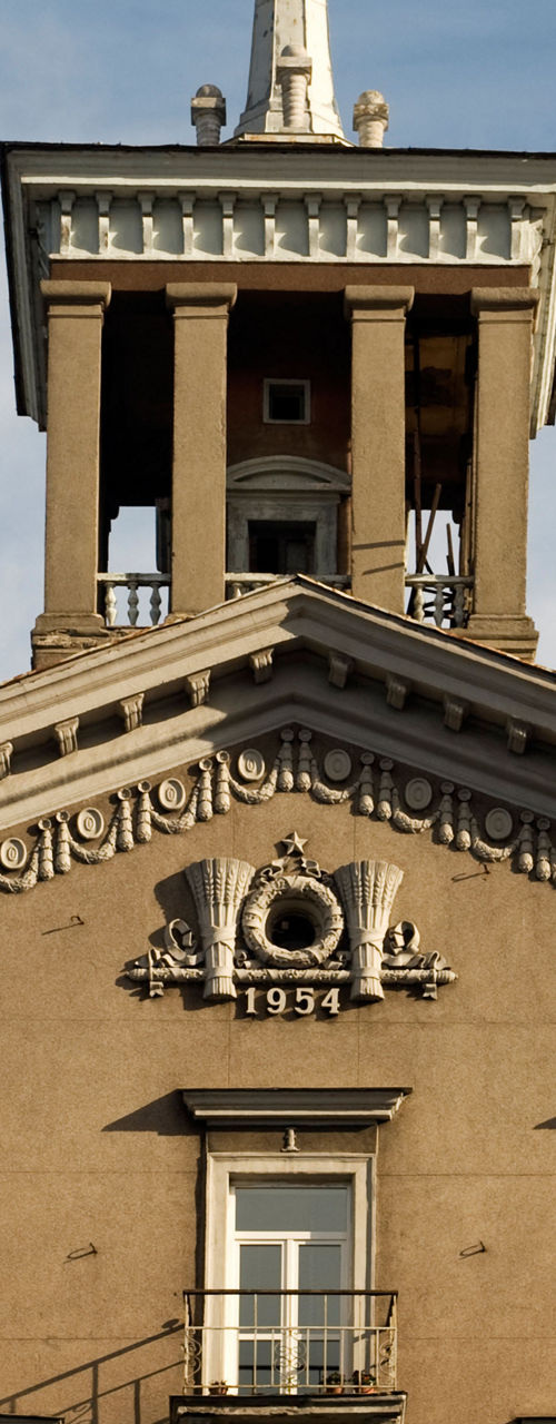 Historic building with spire and emblem