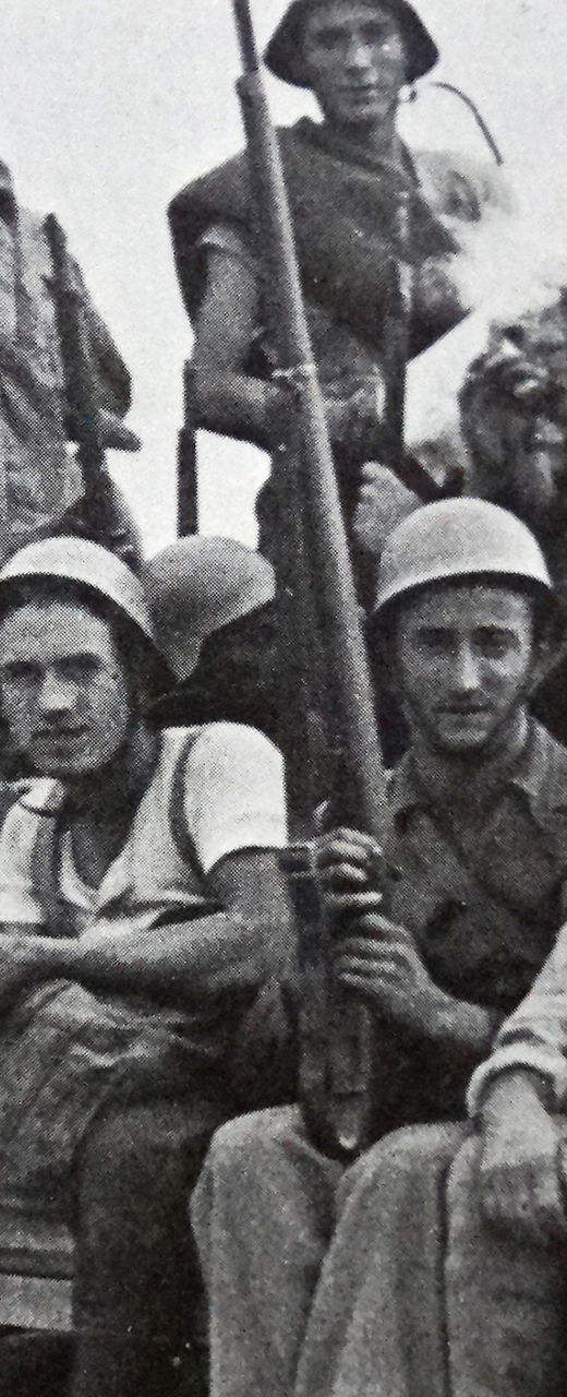 Group of armed soldiers on a truck
