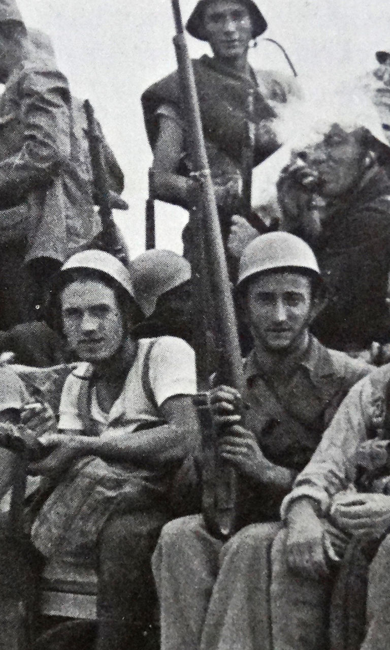 Group of armed soldiers on a truck