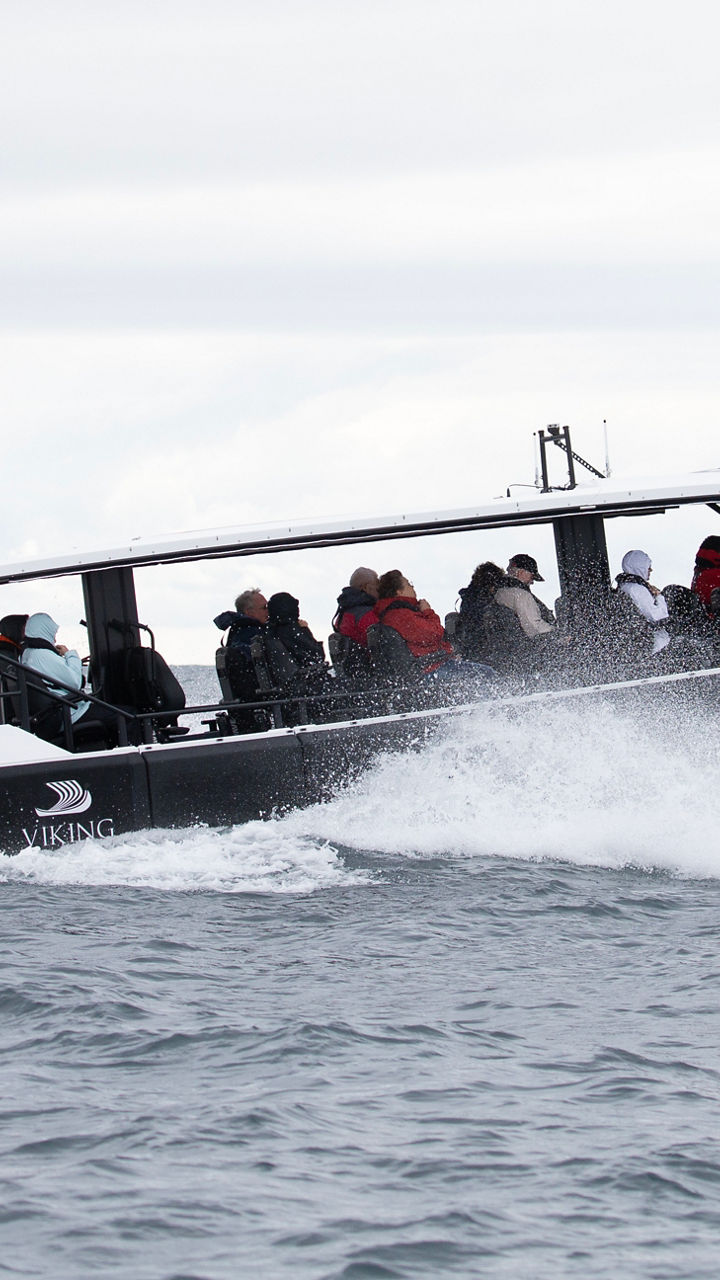 Speedboat with passengers on open water