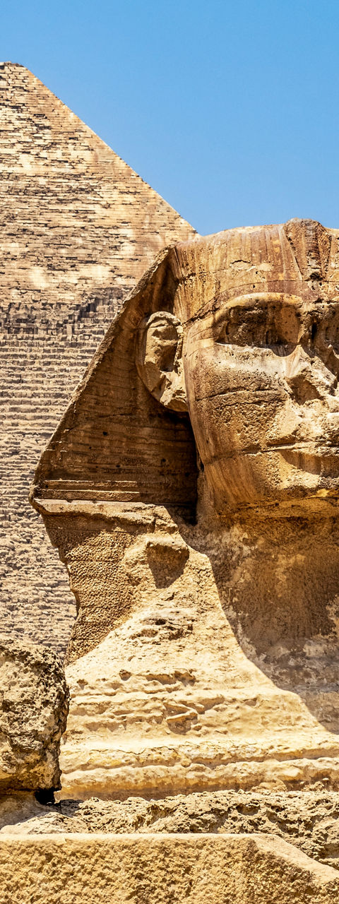 Great Sphinx and Pyramid under blue sky
