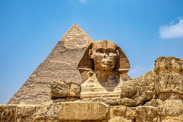 Great Sphinx and Pyramid under blue sky