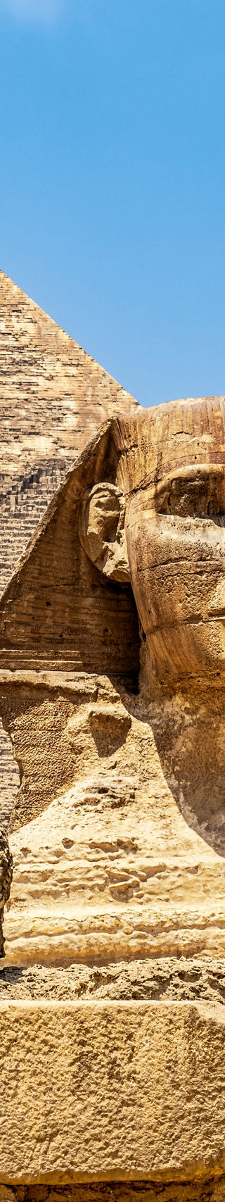 Great Sphinx and Pyramid under blue sky