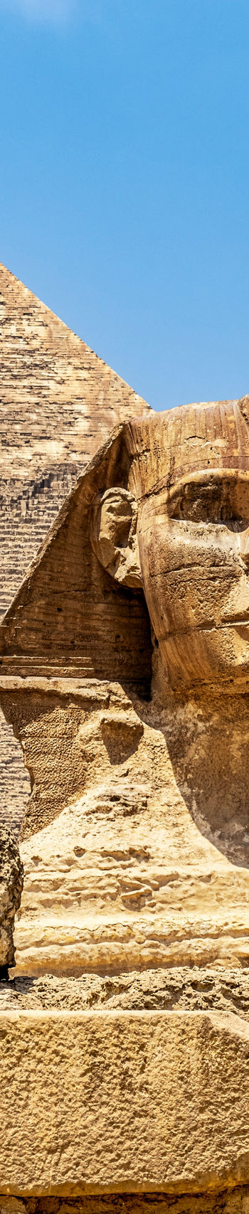 Great Sphinx and Pyramid under blue sky