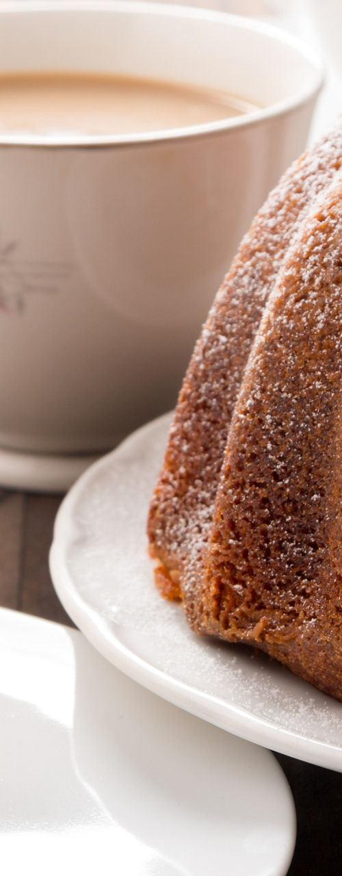 Bundt cake with tea on wooden table
