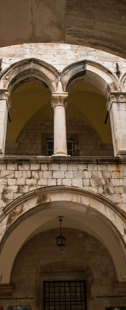 Historic stone courtyard with arches