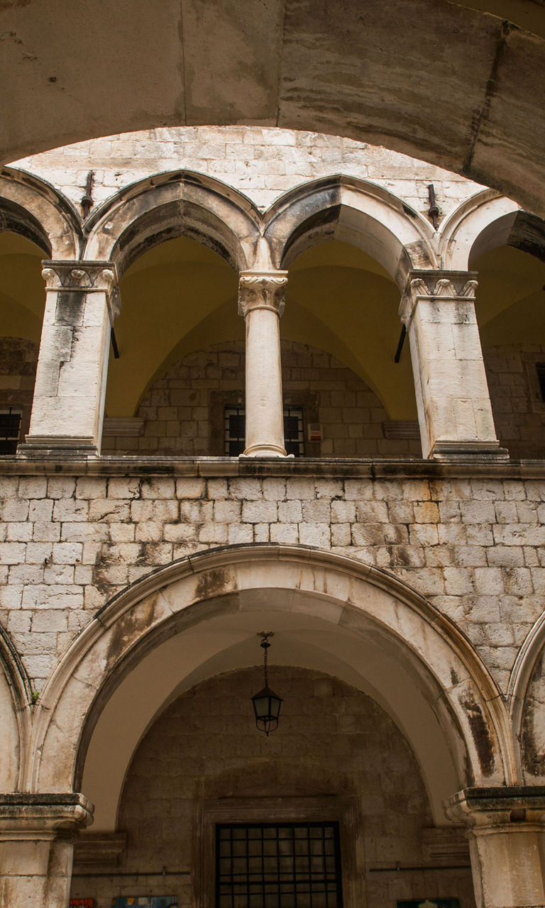 Historic stone courtyard with arches