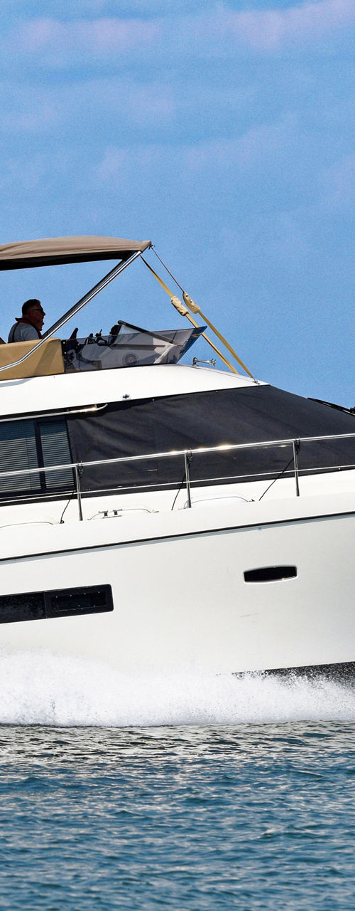 Modern white motor yacht cruising on open water