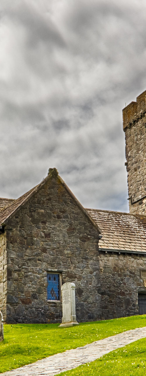 Historic stone church with cemetery and tower
