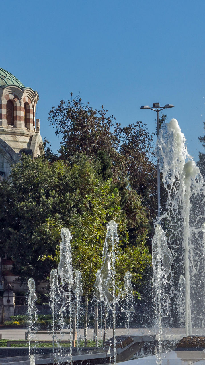 Historic building with fountains in foreground