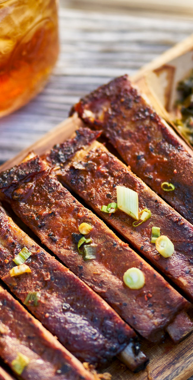 Barbecue ribs with sides on wooden platter