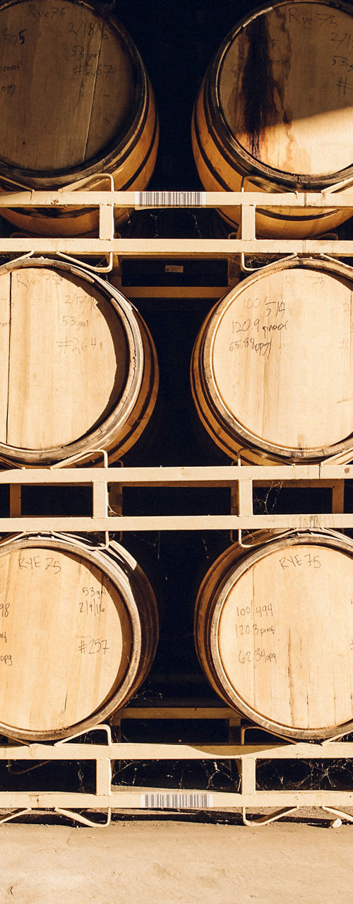 Wooden barrels stacked in a warehouse