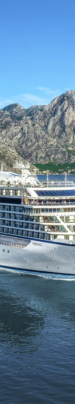 Luxury cruise ship sailing in scenic fjord