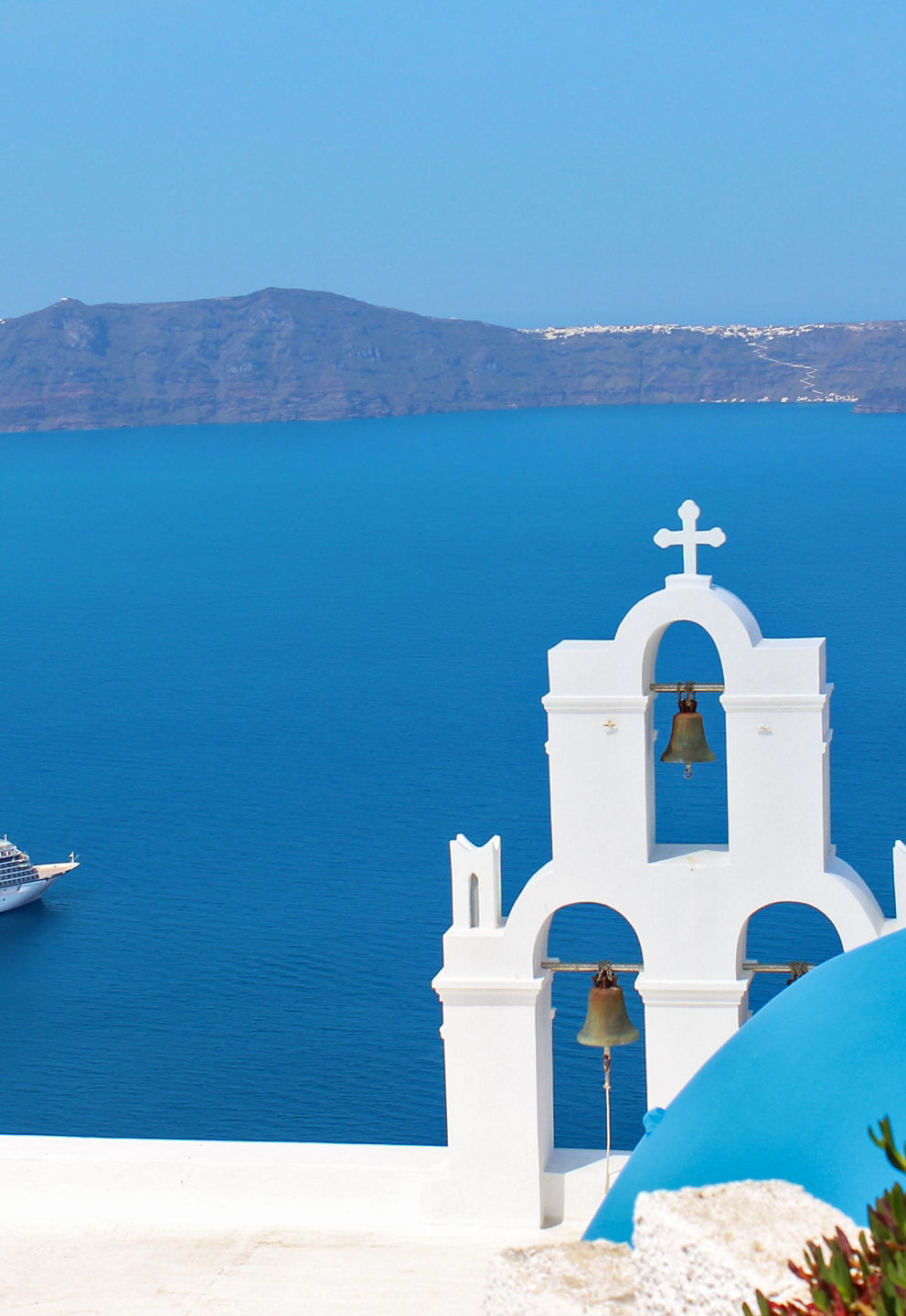 Cruise ship near Santorini with blue dome