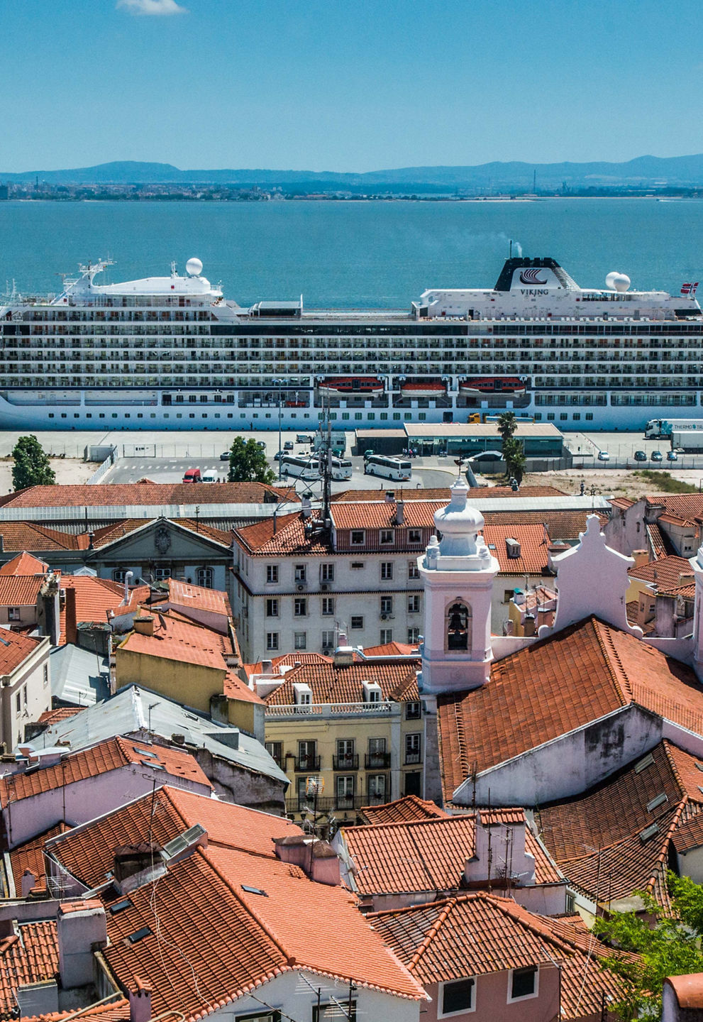 Cruise ship docked near Lisbon rooftops