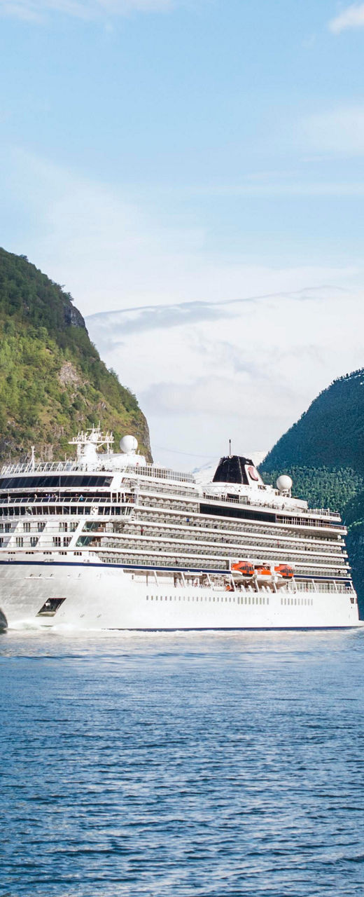 Cruise ship sailing through scenic fjord
