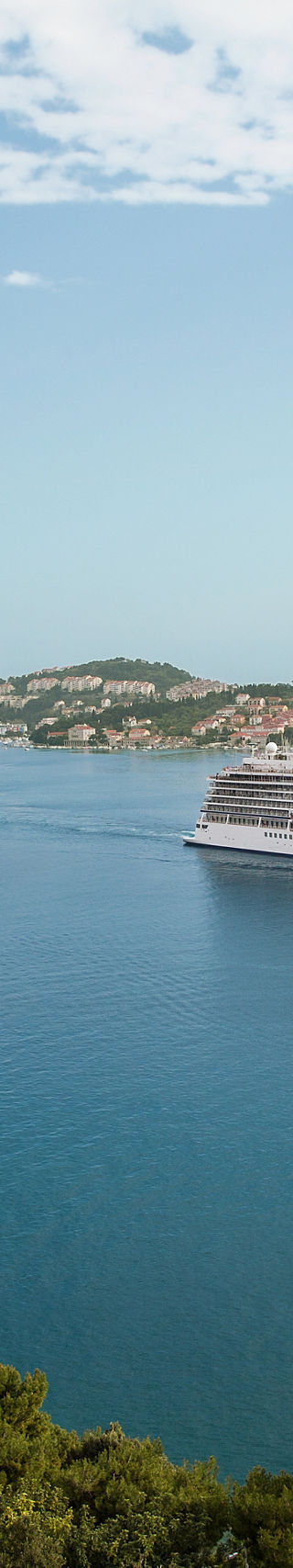 Cruise ship near Dubrovnik bridge and coastline