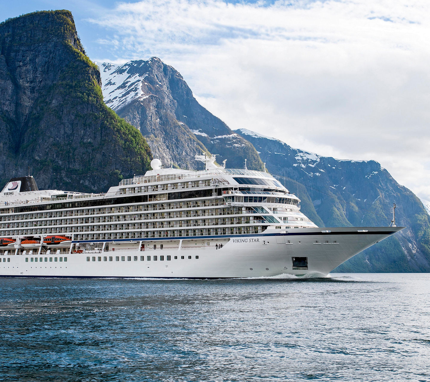 Luxury cruise ship in scenic fjord