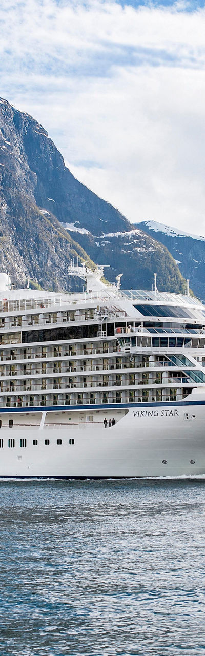 Luxury cruise ship in scenic fjord